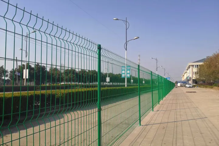 Green welded mesh perimeter fence with posts